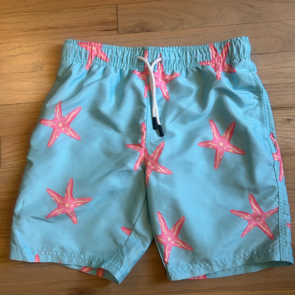 Maamgic brand swim trunks, light blue with pink starfish. Boy’s size 10/12